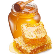 Jar full of fresh honey and honeycombs isolated on white backgro