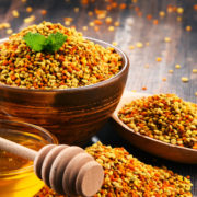 Bowls with bee pollen and honey on kitchen table